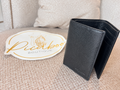 Cartera bifold Coach negra de piel texturizada