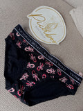 Panty Victoria’s Secret negra con bastones y moños